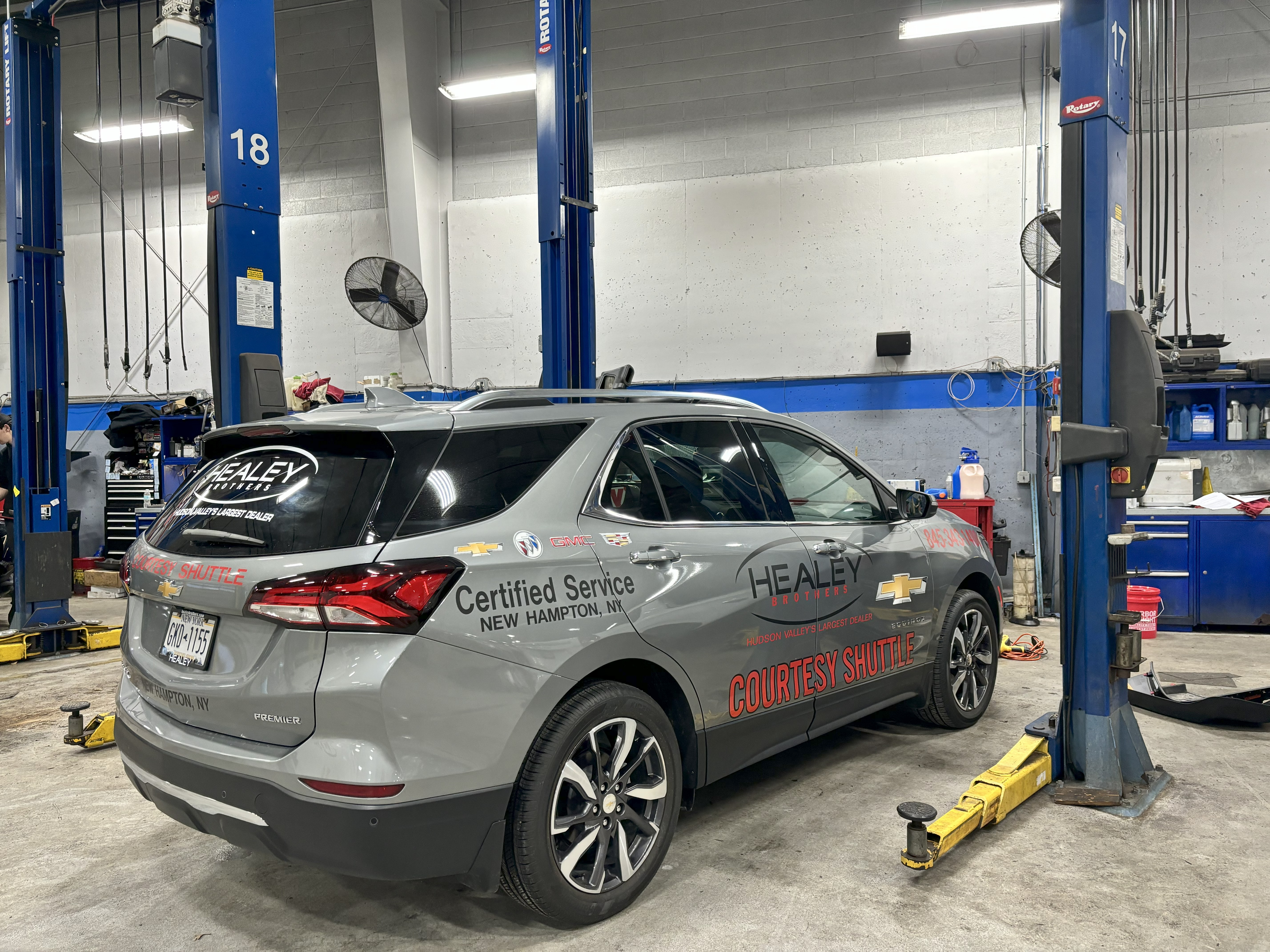 Branded fleet graphics applied to a courtesy shuttle vehicle